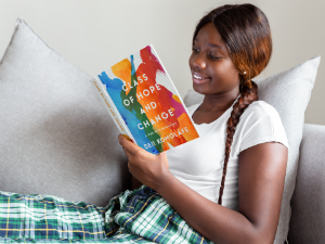 Young lady reading Class of Hope and Change paperback book